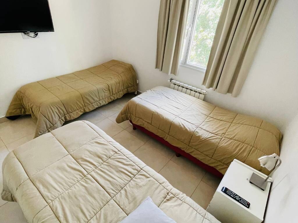 Dormitorio con tres camas de una plaza